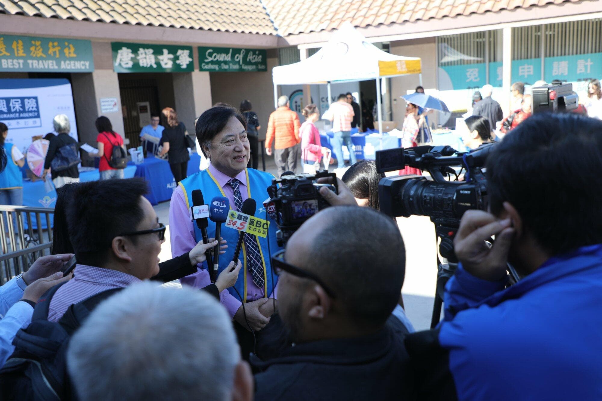 Reporters interview a KCAL representative at the 2020 open enrollment health fair