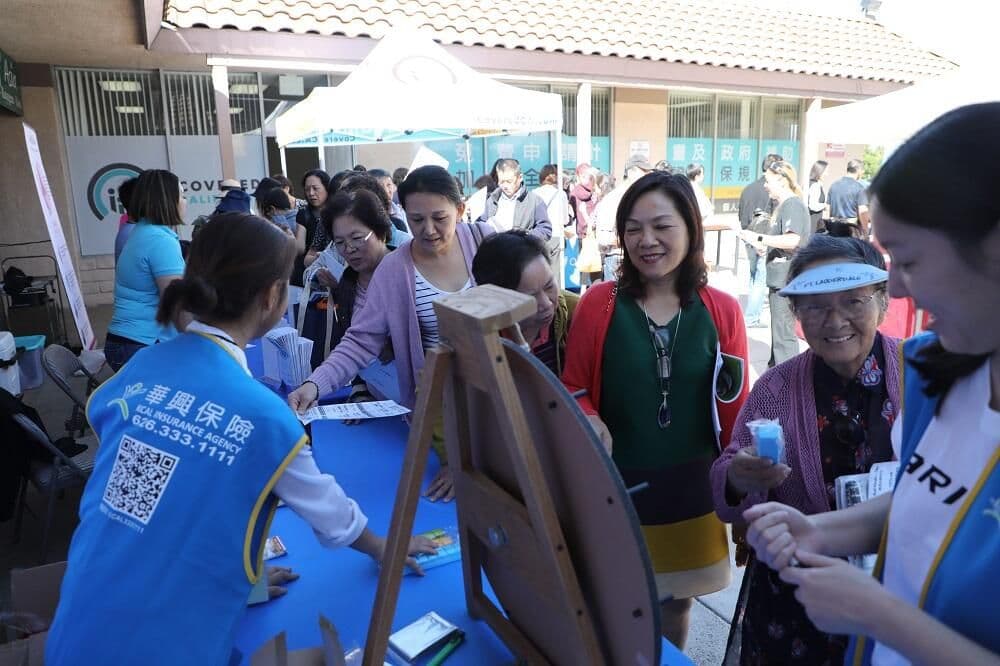 KCAL staff talk with attendees at a booth at the 2020 open enrollment health fair