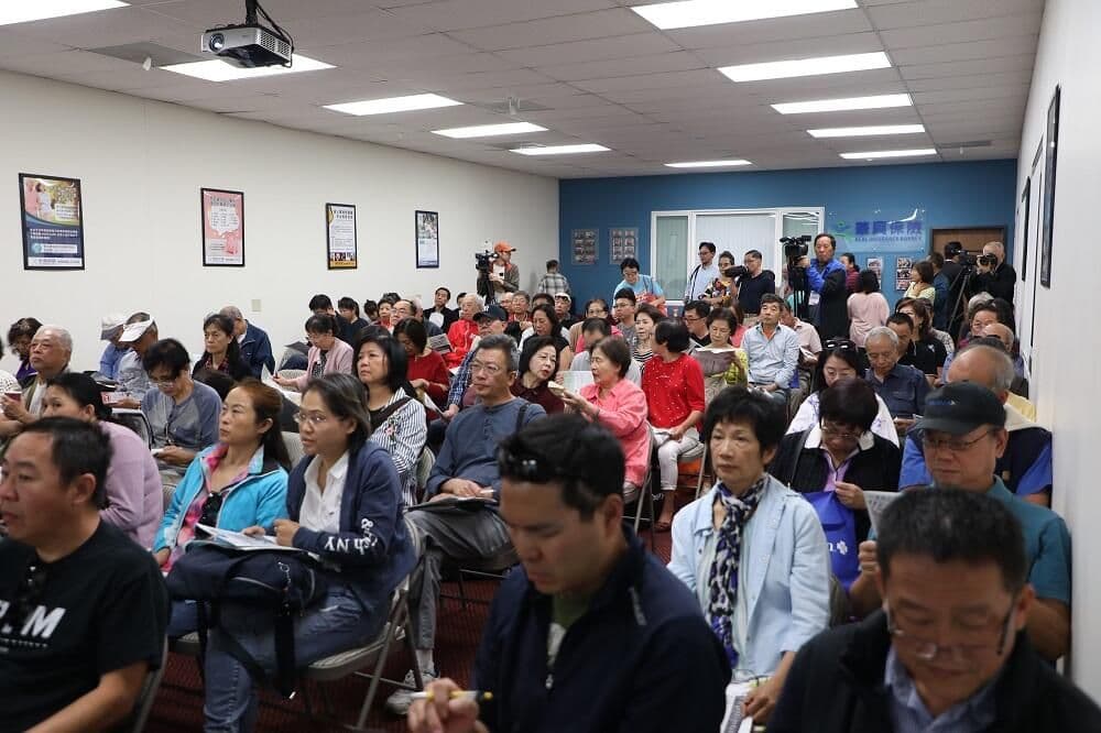 Attendees take notes at a health insurance seminar during KCAL's 2020 health fair