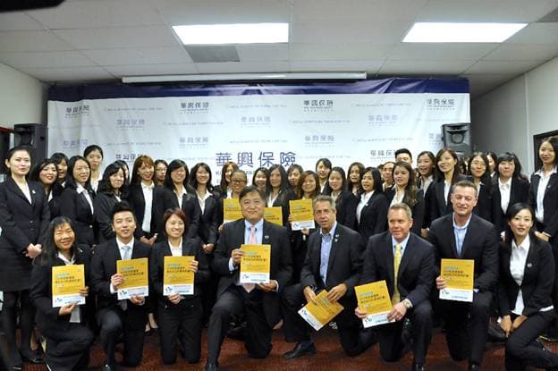 The KCAL team and Covered California representatives hold brochures during the bus tour stop in Hacienda Heights