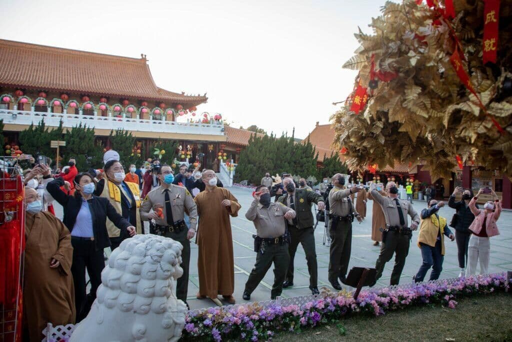 Guests toss wish ribbons onto the wishing tree at Hsi Lai Temple