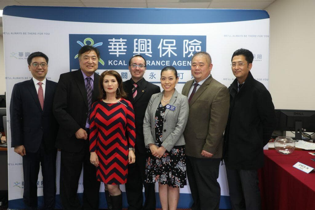Speakers and KCAL representatives pose in front of the KCAL backdrop at the 2018 Seminar for Business Owners