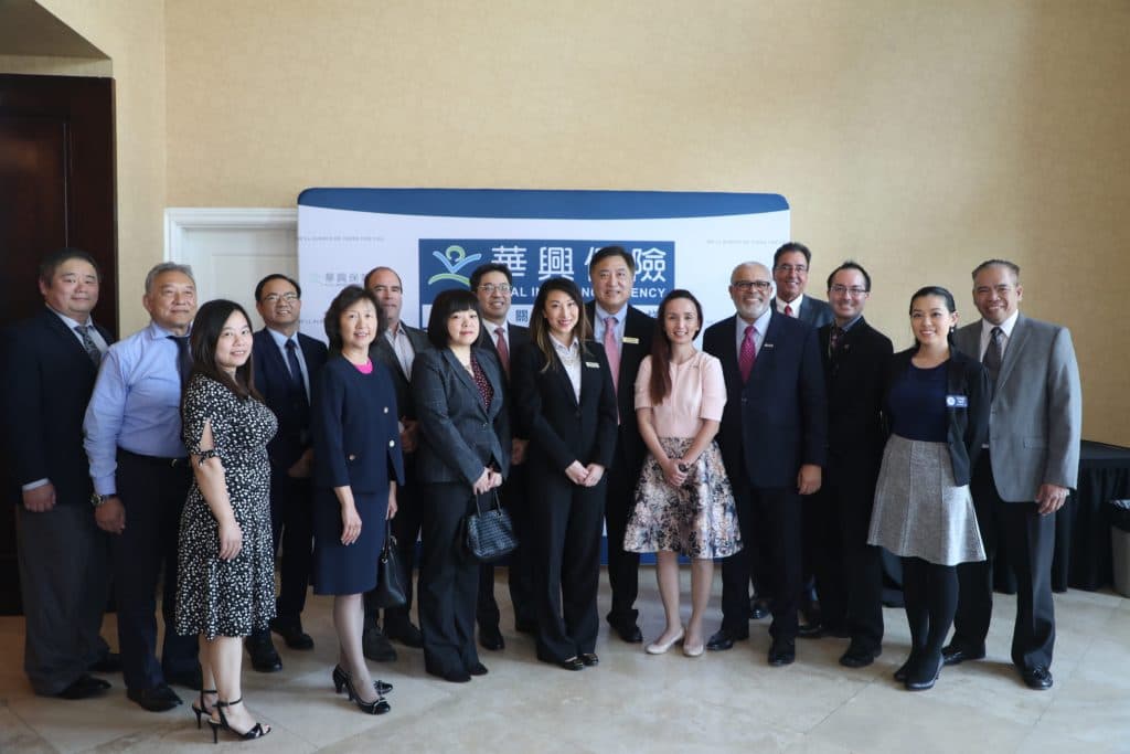 Guest speakers and KCAL staff pose in front of the KCAL backdrop at the 2018 Seminar for Business Owners